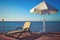 Deckchair and parasol on a wooden quay