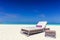 Deckchair on sandy tropical beacha a small island resort in Maldives, Indian Ocean