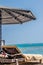 Deckchair under a sun umbrella on the beach