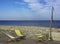 Deckchairs abandoned beside a pebble beach