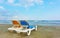 Deckchairs on a sandy beach