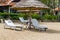 Deckchairs umbrella and chair parasol sun tropical sand beach