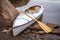 decked expedition canoe with a wooden paddle on a rocky shore of Horsetooth Reservoir near Fort Collins, Colorado