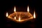 A declarative five facing Earthen Oil Lamp or Diya on dark background