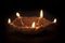 A declarative five facing Earthen Oil Lamp or Diya on dark background