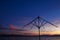 Decline or dawn over the sea. Beautiful clouds of rising or decline are reflected in waves. Silhouette of beach umbrella