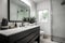 decluttered bathroom with streamlined vanity, sleek faucets and clear countertops