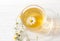A decoction of chamomile flowers in a transparent tea Cup