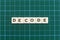 Decode word made of square letter word on green square mat background