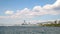 Decommissioned old warship on the coast of Thessaloniki city, Greece, clouds over blue sky and residential buildings