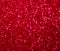 Decompressed abstract red glitter background