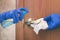 Decontamination of metal door handle. Removing germs from the handle on the front door. Spray with a sanitizer and a rag in a