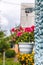 Decor outside the house, pink geraniums in a hanging flowerpot on the wall of the house