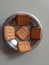 Decorate biscuits in steel bowl.