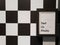 Decorate black photo frame on black and white chessboard pattern wall