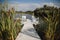 Decorated area for marriage registration on the lake. White bridge, fresh flowers, textiles.