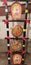 A decorated  bamboo ladder with red ,white, yellow, ribon and handmade painting on clay dish used for diwali pandal.