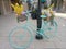 Decorated bicycle with colourful flowers placed next to a pole on the city street