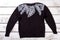 Decorated black sweater.