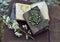 Decorated book and open diary with flowers on planks outdoors.