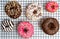 Decorated chocolate donuts on a baking grid