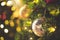 Decorated Christmas tree on blurred varicolored new year`s background  . Christmas Ornament On Wooden Background With Snowflakes,