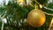 Decorated christmas tree with gold holiday balls, an electric garland is sparkling and blinking close up, new year and
