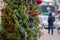 Decorated Christmas tree and pedestrians on a city