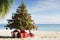 A decorated christmas tree on a tropical beach. Seasonal festive winter travel vacation
