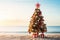 A decorated christmas tree on a tropical beach. Seasonal festive winter travel vacation