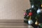 Decorated christmas tree with wooden table and blurred background