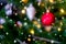 Decorated closed up Christmas tree on blurred, sparkling snowing and fairy abstract background of holiday lights