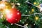 Decorated closed up Christmas tree on blurred, sparkling snowing and fairy abstract background of holiday lights