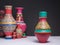 Decorated colorful pottery vase on background of blurred colorful vases