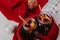 Decorated composition of mugs with mulled wine in knitted scarf, close up
