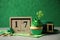 Decorated cupcake, block calendar, hat and coins on grey table. St. Patrick`s Day celebration