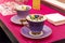 Decorated cups of violet tea service