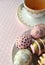Decorated Easter eggs in a bowl, closeup on pastel background