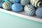 Decorated Easter eggs in a bowl, closeup on pastel background