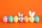 Decorated Easter eggs and cute bunny`s ears on background