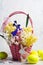 Decorated Easter eggs and spring flowers in a basket