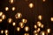 Decorated electric garland for lighting with bulbs warm white and yellow light on a dark background. Blurred background. Bulbs in