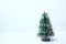 Decorated fake Christmas tree isolated on white background