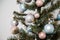 decorated fir tree with pink, blue, white and silver bulbs. Merry Christmas, Happy New Year and winter holidays