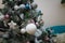 decorated fir tree with pink, blue, white and silver bulbs, stars and artificial snow. Merry Christmas, Happy New Year