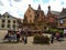 The decorated with flowers Fountain in the central square of Eguisheim surrounded by typical houses of Alsace, France.
