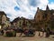 The decorated with flowers Fountain in the central square of Eguisheim surrounded by typical houses of Alsace, France.