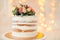 Decorated by flowers white naked cake, rustic style for weddings, birthdays and events.