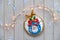 Decorated gingerbread. Cartoon Santa character on bauble with bow and holly. Creative traditional gifts for children