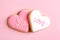 Decorated heart shaped cookies on color background, top view.